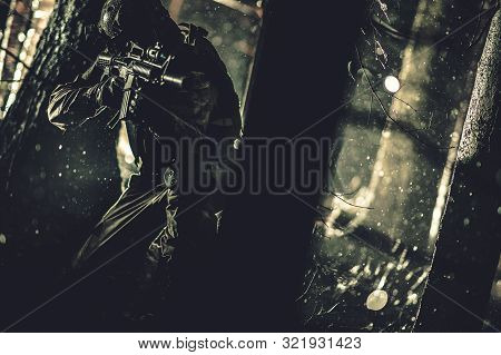 Army Special Forces Operation At Night. Soldier With Assault Rifle Covering Between Trees. Military 