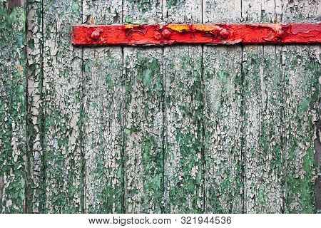 Vintage Green Peeling Paint Wooden Door With A Red Peeling Paint Hinge