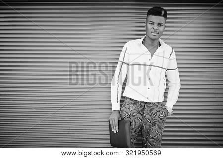 Portrait Of Handsome Stylish African American Model Man In Red Throusers And White Shirt With Laptop