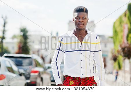 Portrait Of Handsome Stylish African American Model Man In Red Throusers And White Shirt Posed At St
