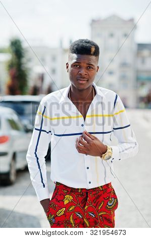 Portrait Of Handsome Stylish African American Model Man In Red Throusers And White Shirt Posed At St