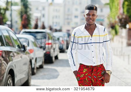 Portrait Of Handsome Stylish African American Model Man In Red Throusers And White Shirt Posed At St