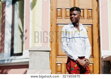 Portrait Of Handsome Stylish African American Model Man In Red Throusers And White Shirt.