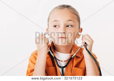 Pensive Child Holding Stethscope And Looking Away Isolated On White