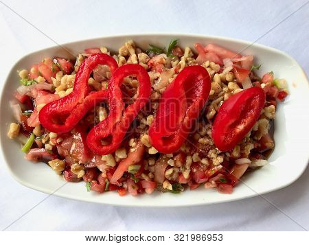 Turkish Salad Gavurdagi With Walnut, Tomatoes And Sliced Red Peppers Slices.