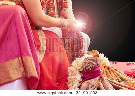 Indian Wedding Ceremony, Bride And Groom Holding Fire In Hands On Black Background With Copy Space
