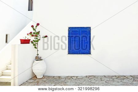 Blue Wooden Window And Bougainvillea Flower At Koufonisia Islands Greece
