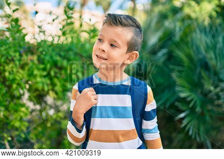 dorable caucasian student boy smiling happy standing at the park.