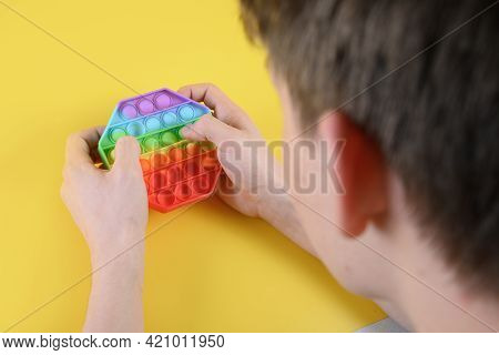 Teenger Playing With Popular Silicone Antistress Pop It Hexagon Toy.