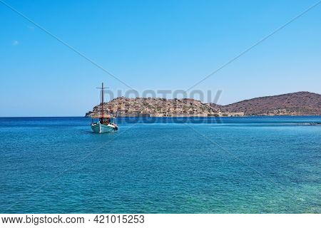 Spinalonga Island In Elounda, Agios Nikolao District Cretes With A Transfer Ship In The Foreground