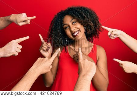 Beautiful african american woman with afro hair with fingers around pointing to herself smiling and looking at the camera pointing with two hands and fingers to the side. 