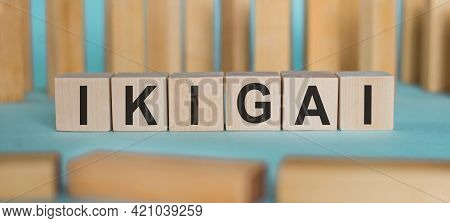 Word Ikigai On Wooden Cubes On A Blue Background
