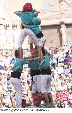 Tarragona, Spain, September 19, 2019 - Children Complete Erection Of Human Castells Tower By Climbin