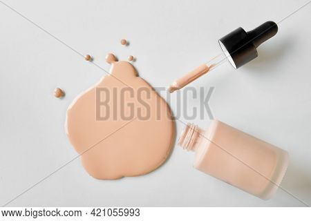 Mockup Glass Bottle Of Correction Cosmetic Product With Pipette. Spilled Liquid Foundation. Beauty B
