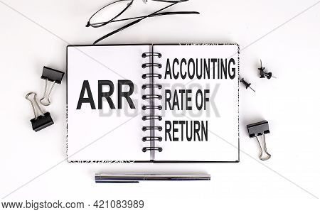 Notebook With Arr Accounting Rate Of Return On The Table With Office Tools