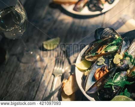 Blue Mussles With Vine And Baguette On Wooden Table
