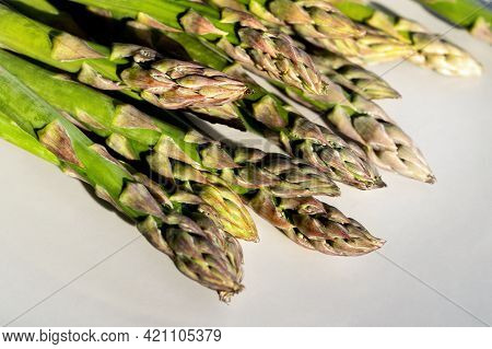 Close-up Detail Bunch Of Fresh Raw Green Asparagus Plant Harvested At Season On Blue Rustic Fabric K