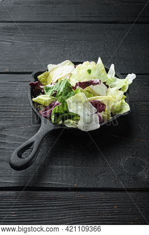 Fresh Green Salad With Spinach,arugula,romaine And Lettuce Set, In Frying Cast Iron Pan Or Pot, On B