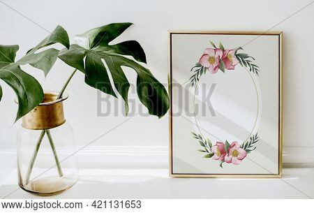 Floral golden frame by monstera leaves