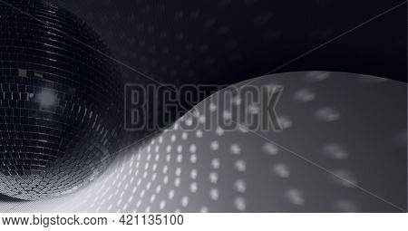Composition of disco mirror ball casting row of spot of light in music venue. entertainment and music event venue concept digitally generated image.