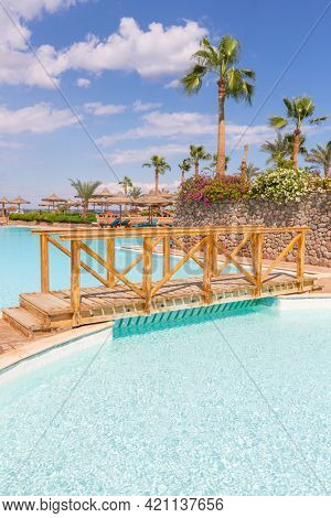Man jums into the swimming pool in african camping