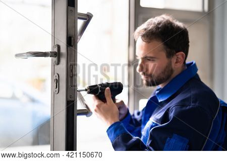 Locksmith Man Repairing And Changing Metal Door Lock