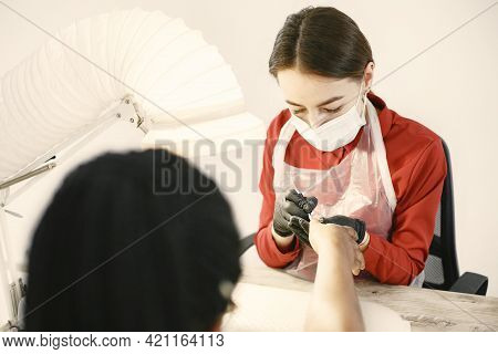 African Girl Doing Manicure In A Beauty Salon