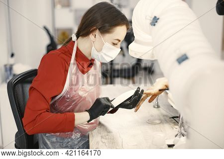African Girl Doing Manicure In A Beauty Salon