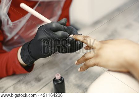 African Girl Doing Manicure In A Beauty Salon