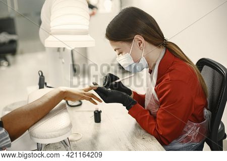 African Girl Doing Manicure In A Beauty Salon