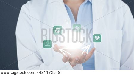 Composition of male doctor holding screen with medical data processing. global medicine and healthcare concept digitally generated image.