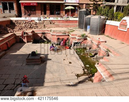 Life Of Nepali People Wait Queue For Receive Water In Ancient Building Antique Pool Pond After Earth