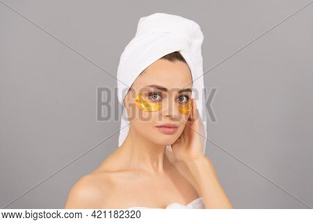 Sensual Lady With Terry Towel Use Facial Golden Eye Patch For Skin, Spa