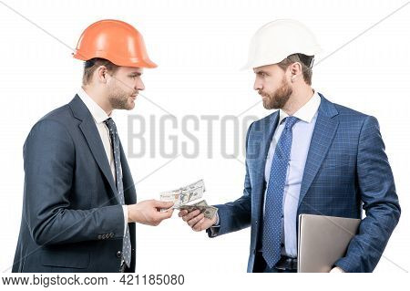 Investors Men In Suit And Safety Helmet Giving Or Taking Money And Hold Computer, Investment