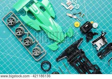 Flatlay Mini 4wd Toy Car And Components To Be Assemble On Cutting Mat. Popular Toy Car During 90's.