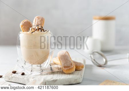 Sweet Tiramisu Cocktail, Milk Shake In A Glass And Savoyardi On Bright Background. Sweet Summer Cock