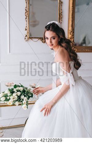 Beautiful Brunette Bride Posing In White Dress With Wedding Bouquet In Studio