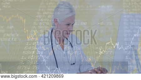 Financial data processing over doctor typing on a computer, economy and healthcare concepts. digitally generated image