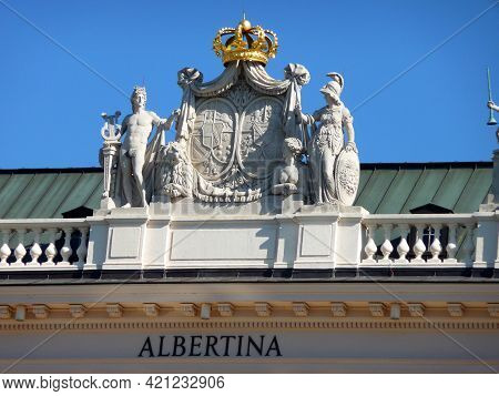A Crest, A Crown And Sculptures On The Roof.