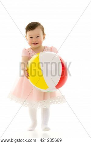 Little Girl Is Playing With A Ball.the Concept Of Childrens Sports, Summer Outdoor Recreation.
