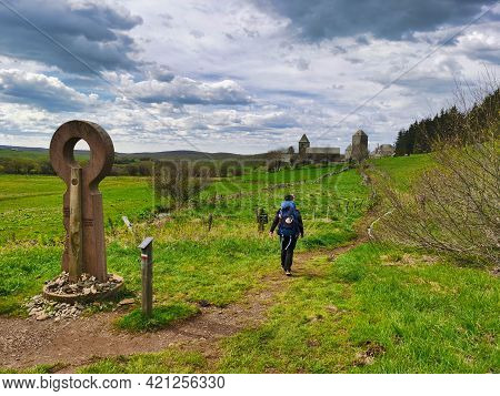 Pilgrim Arriving In Aubrac, French Part Of The Camino De Santiago. Way Of Saint James.
