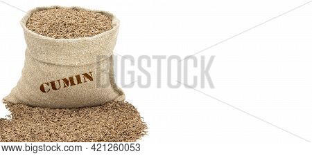 Seeds Of Cumin In A Sack Isolated On A White Background. Caraway Seeds. Caraway In A Burlap Sack. He
