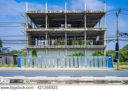 Asia Commercial Building In Underconstruction Process Beside The Road With Galvanized Sheet Facade A