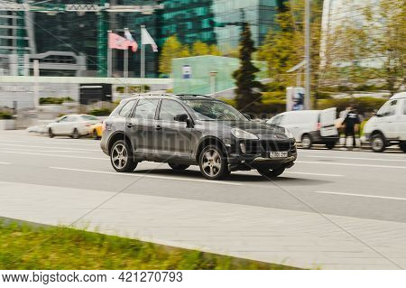 Man Driving Old Porsche Cayenne 955. Black Used Suv Rides On Street On High Speed. Moscow, Russia - 