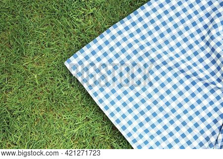 Blue Checkered Picnic Cloth On Green Grass Top View. Checkered Towel Country Design Backdrop. Food A