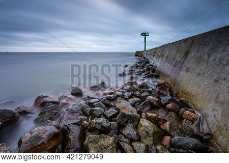 Concrete Breakwater Ended With A Lighthouse. Winter Season. Jastarnia, Baltic Sea, Poland.