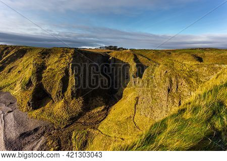View Of The Path To The Dunnottar Castle Between Green Hills. Beautiful Sunny Morning. Stonehaven, A