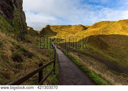 View Of The Path To The Dunnottar Castle Between Green Hills. Beautiful Sunny Morning. Stonehaven, A