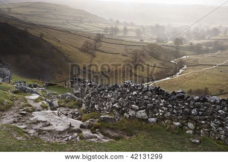View Of Misty Malham Dales From Limestone Pavement Above Malham Cove In Yorkshire Dales National Par