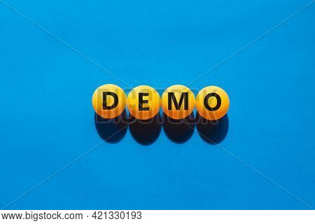 Business And Demo Symbol. Orange Table Tennis Balls With The Word 'demo'. Beautiful Blue Background,